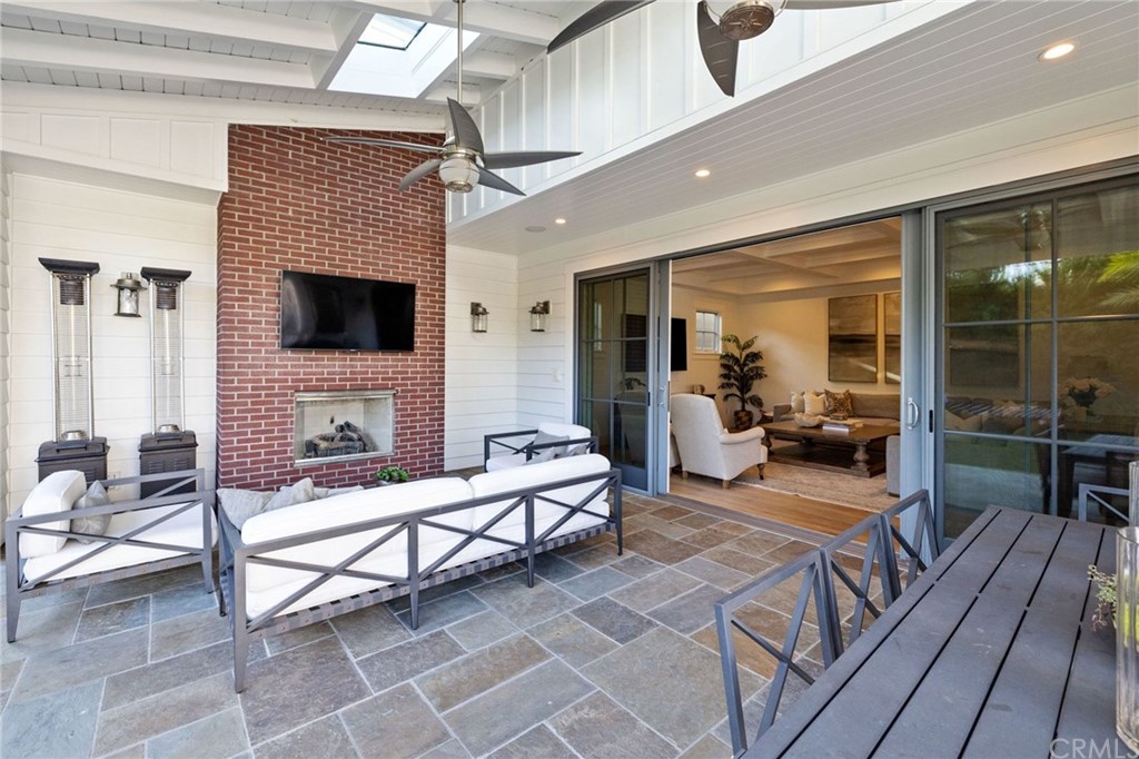 1120 6th Street Manhattan Beach, CA 90266 - Photo 31 of 64 a living room with furniture a fireplace and a flat screen tv