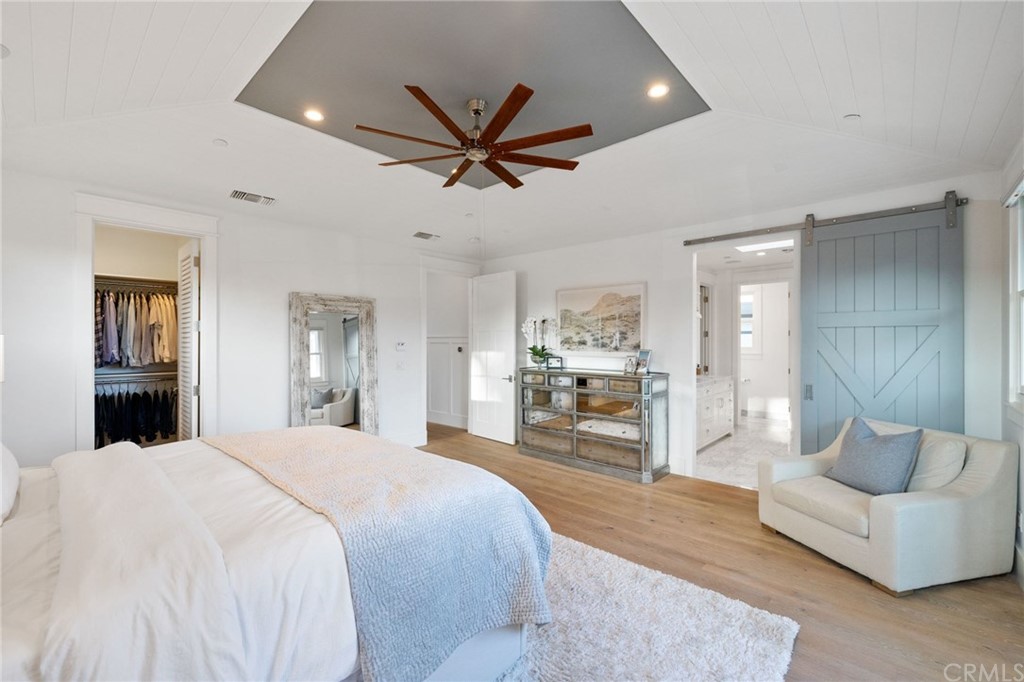 1120 6th Street Manhattan Beach, CA 90266 - Photo 36 of 64 a spacious bedroom with a bed mirror and couch