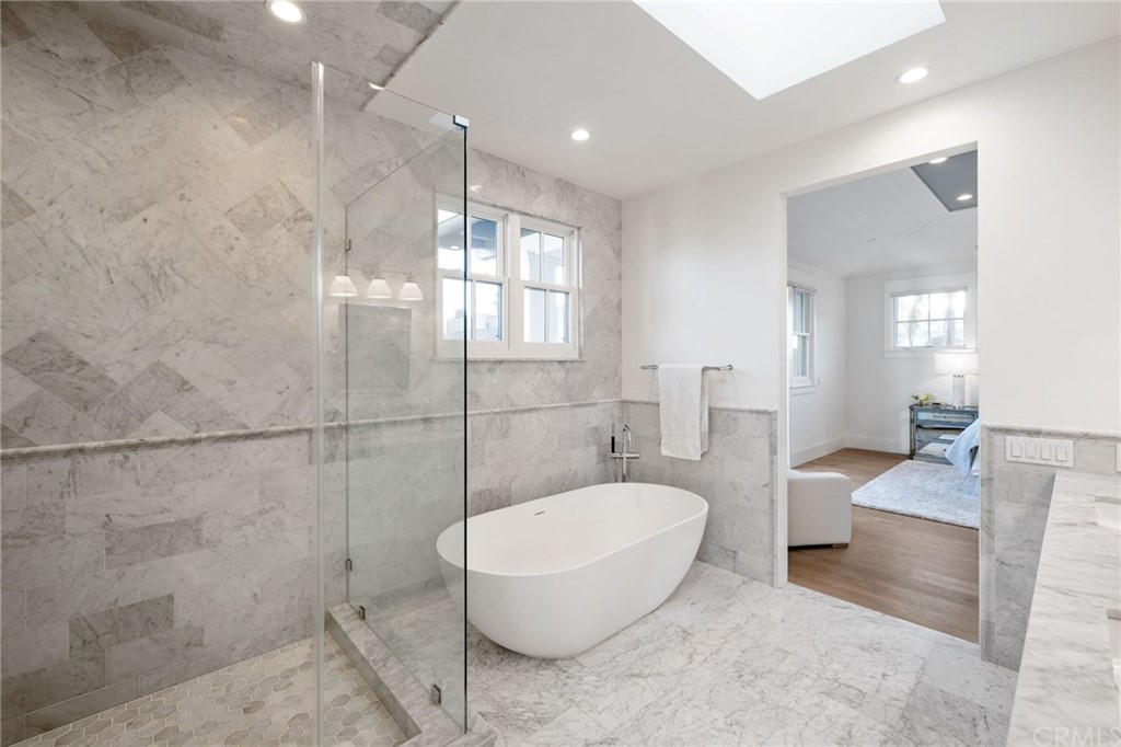 1120 6th Street Manhattan Beach, CA 90266 - Photo 39 of 64 a spacious bathroom with a granite countertop tub sink and glass door