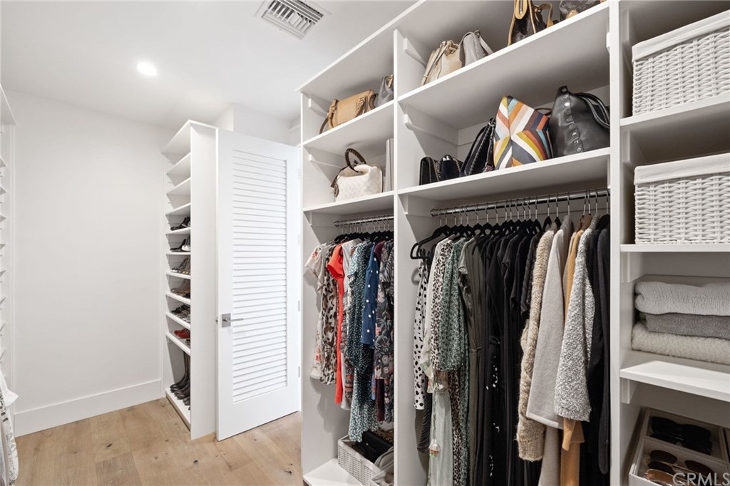 1120 6th Street Manhattan Beach, CA 90266 - Photo 42 of 64 a view of walk in closet with clothes and shoes