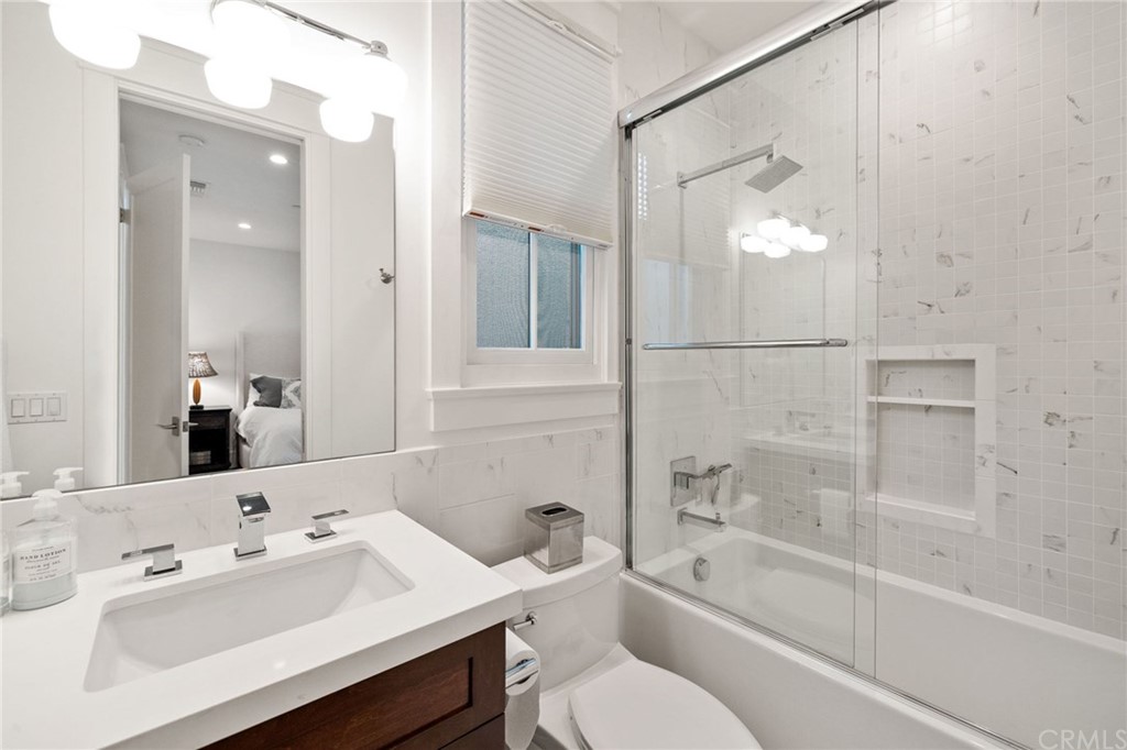 1120 6th Street Manhattan Beach, CA 90266 - Photo 57 of 64 a bathroom with a bathtub shower sink vanity and toilet