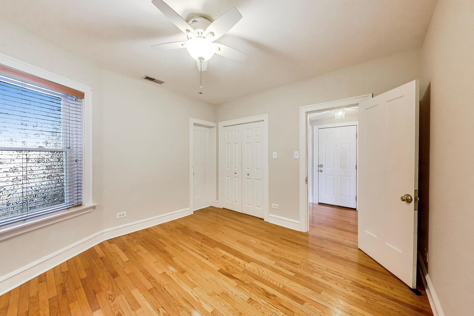 1734 West Foster Avenue, Unit 1 Chicago, IL 60640 - Photo 11 of 24 a view of empty room with wooden floor and fan