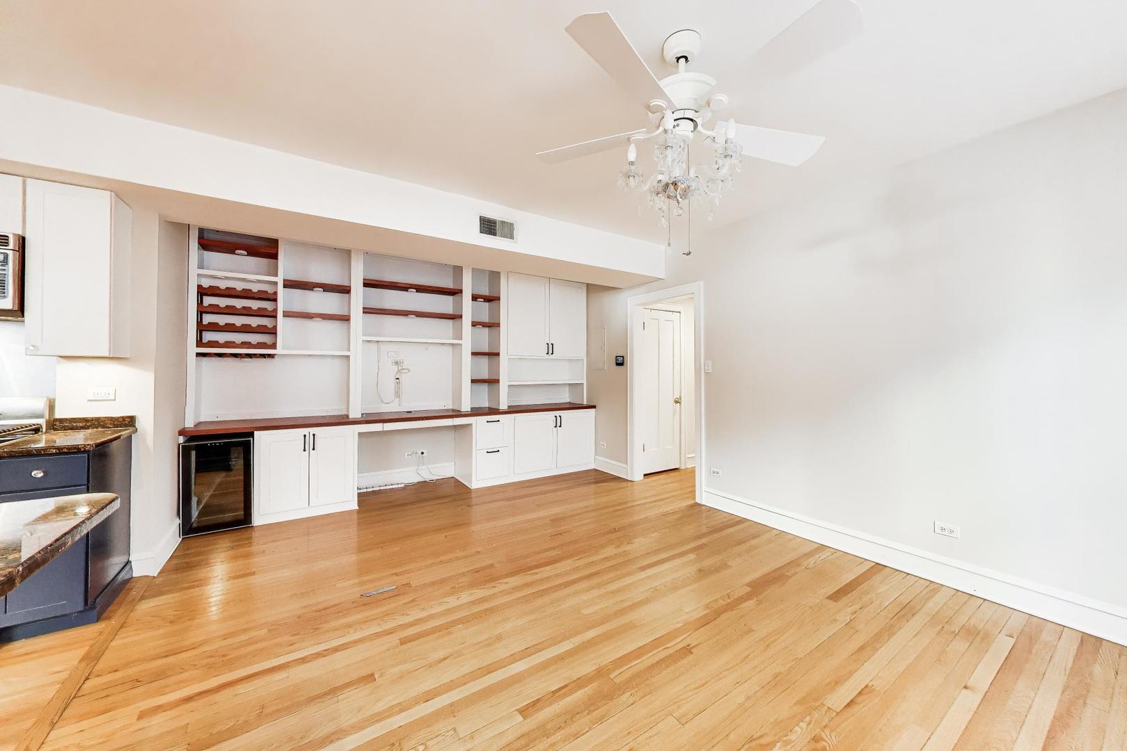 1734 West Foster Avenue, Unit 1 Chicago, IL 60640 - Photo 17 of 24 a view of a kitchen with wooden floor and cabinets