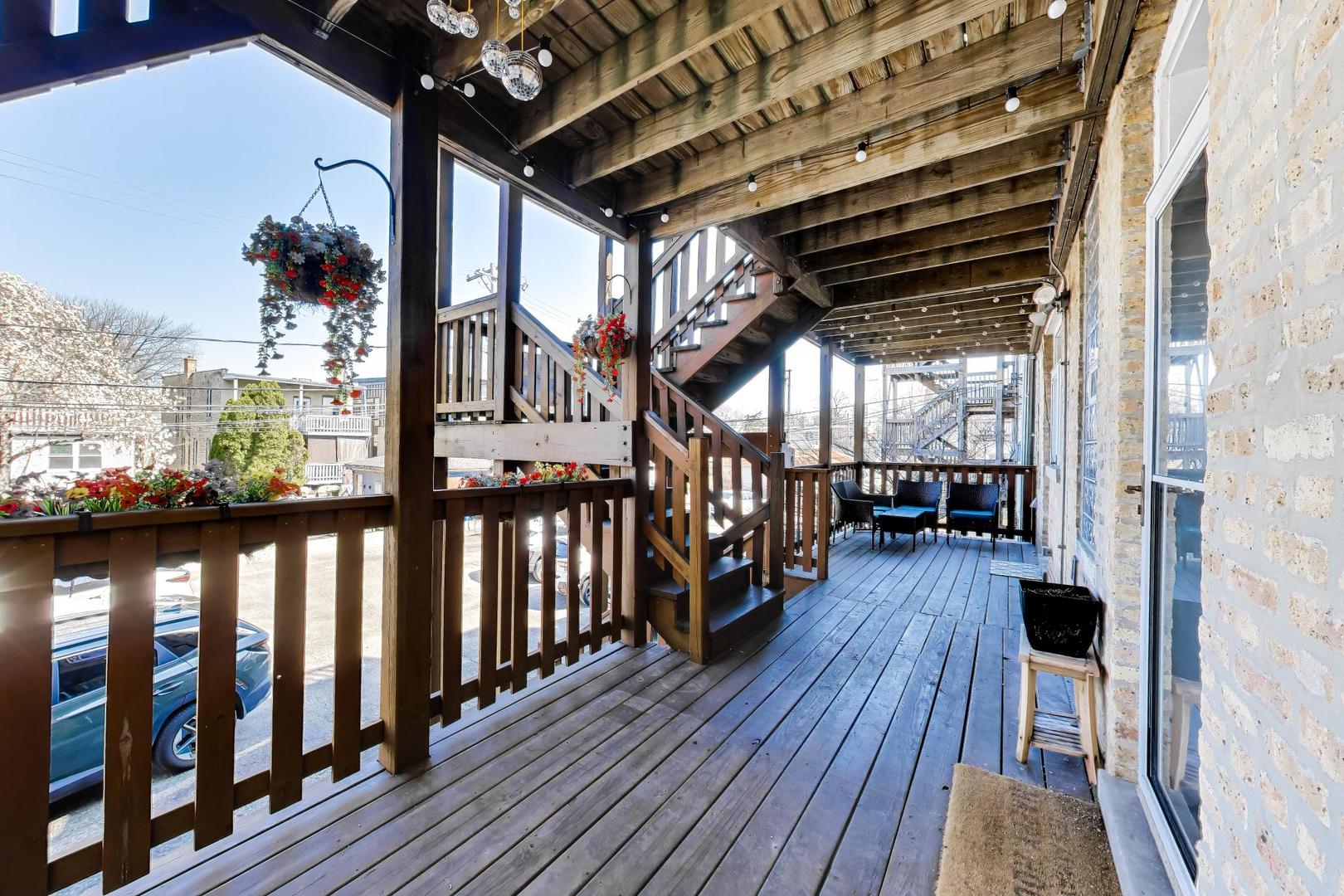 1734 West Foster Avenue, Unit 1 Chicago, IL 60640 - Photo 22 of 24 a view of a balcony with wooden floor
