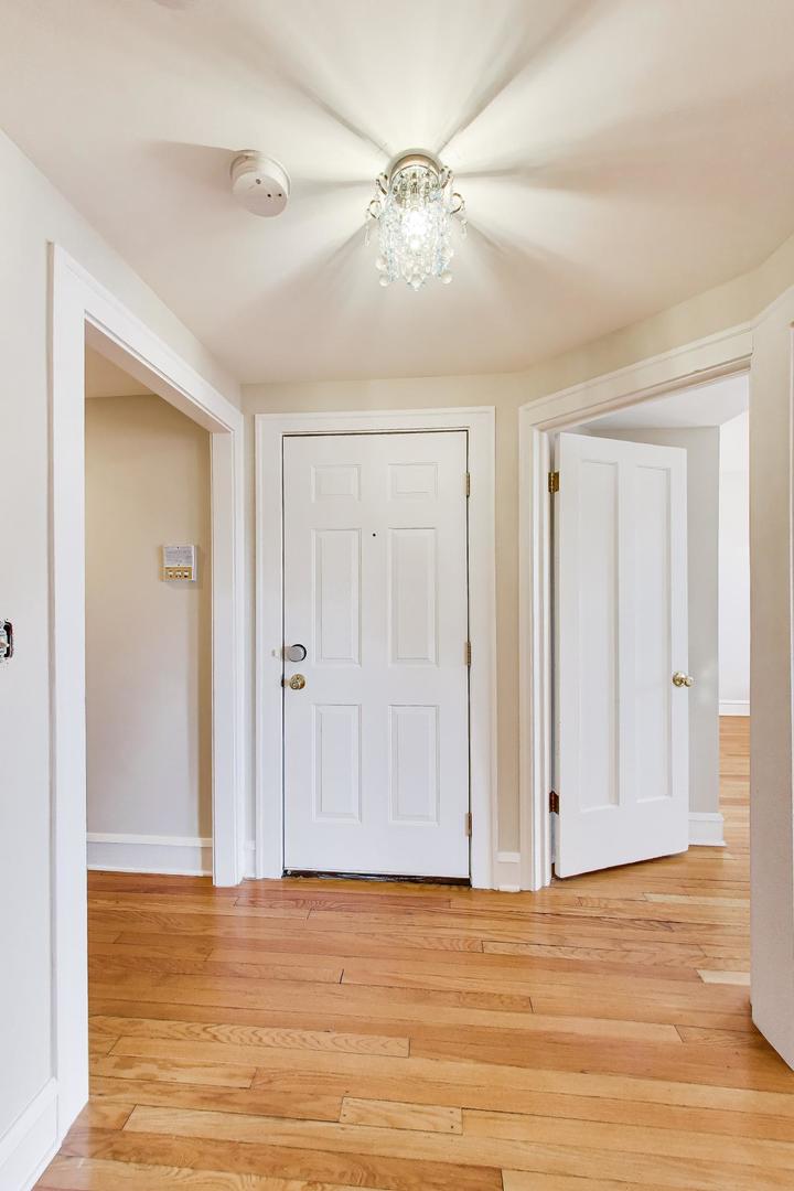1734 West Foster Avenue, Unit 1 Chicago, IL 60640 - Photo 5 of 24 a view of empty room with wooden floor and fan