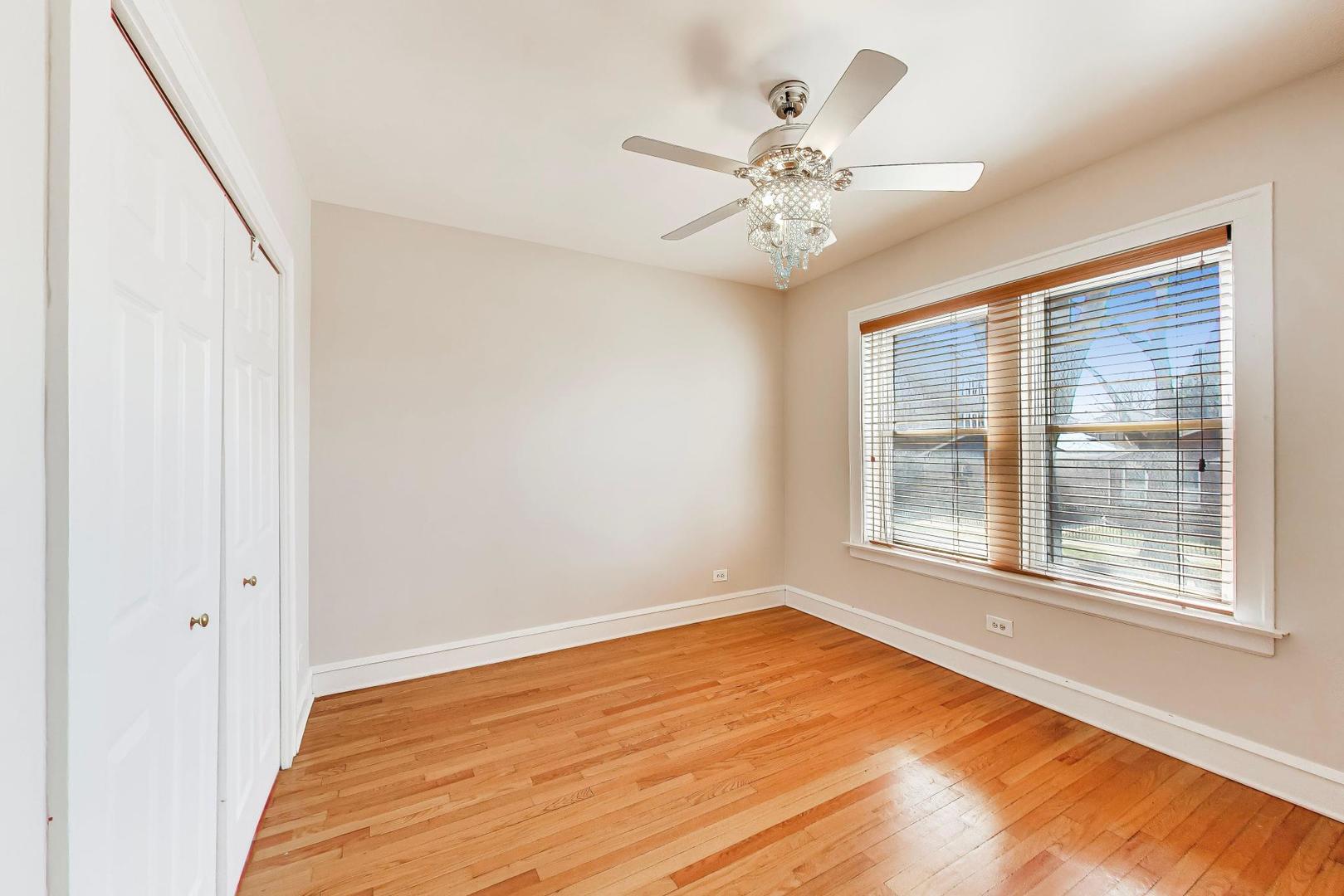 1734 West Foster Avenue, Unit 1 Chicago, IL 60640 - Photo 6 of 24 a view of an empty room with wooden floor and a window