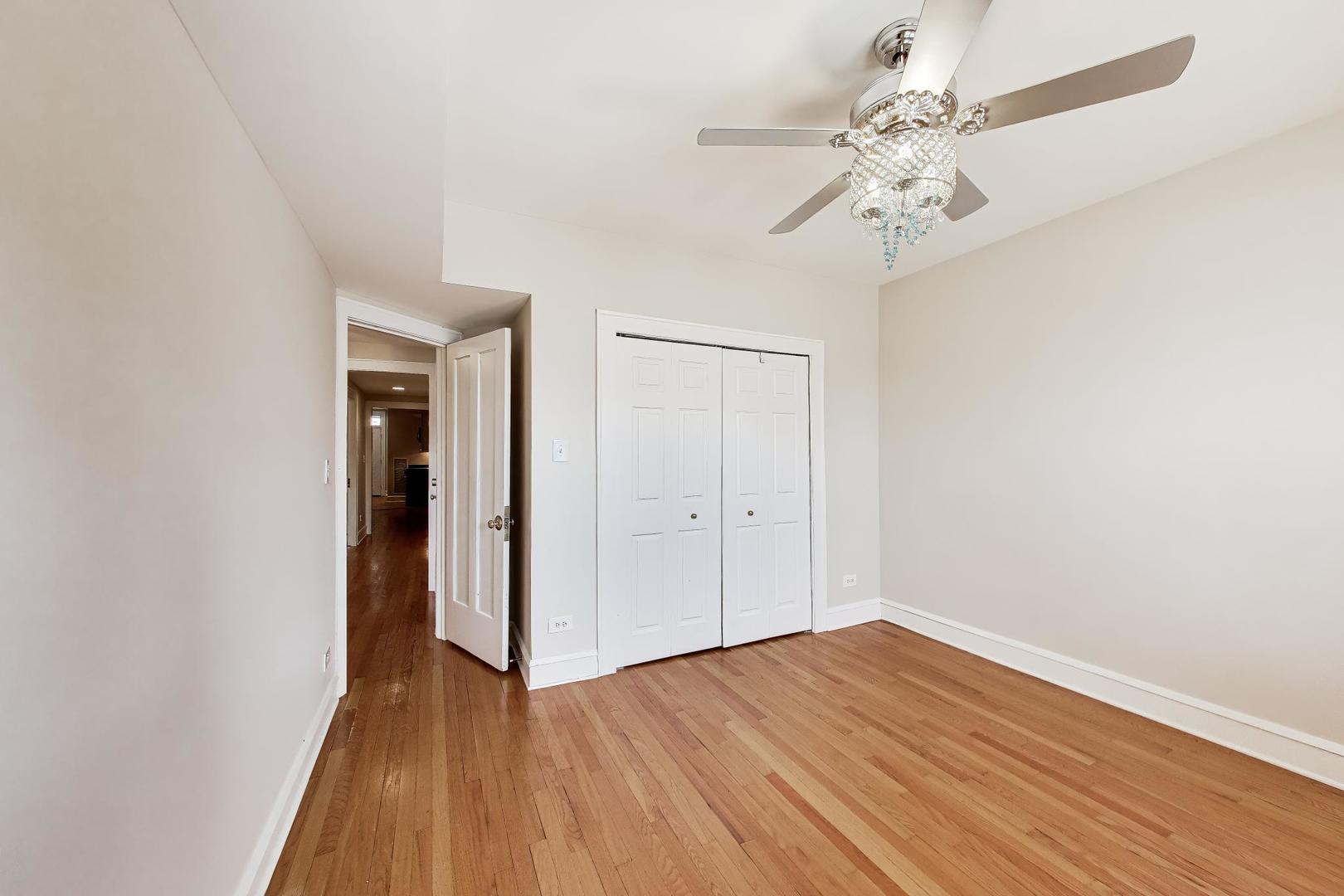 1734 West Foster Avenue, Unit 1 Chicago, IL 60640 - Photo 8 of 24 a view of an empty room with wooden floor