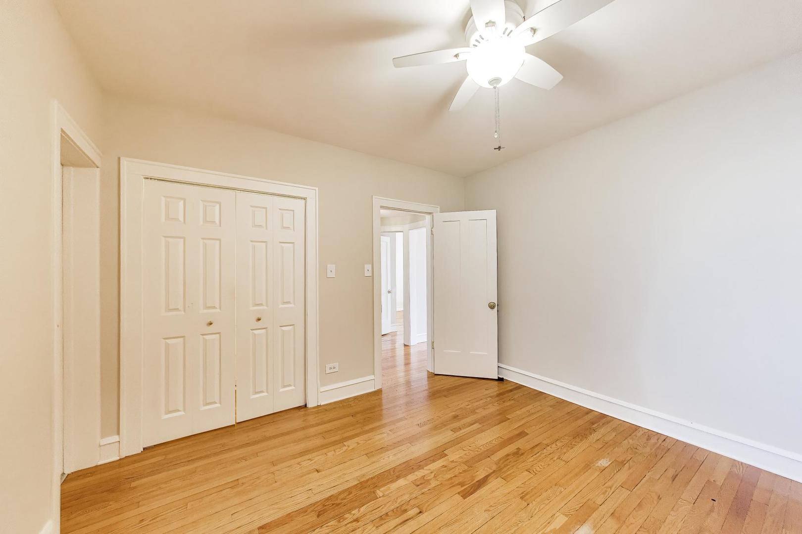 1734 West Foster Avenue, Unit 1 Chicago, IL 60640 - Photo 10 of 24 a view of an empty room with wooden floor