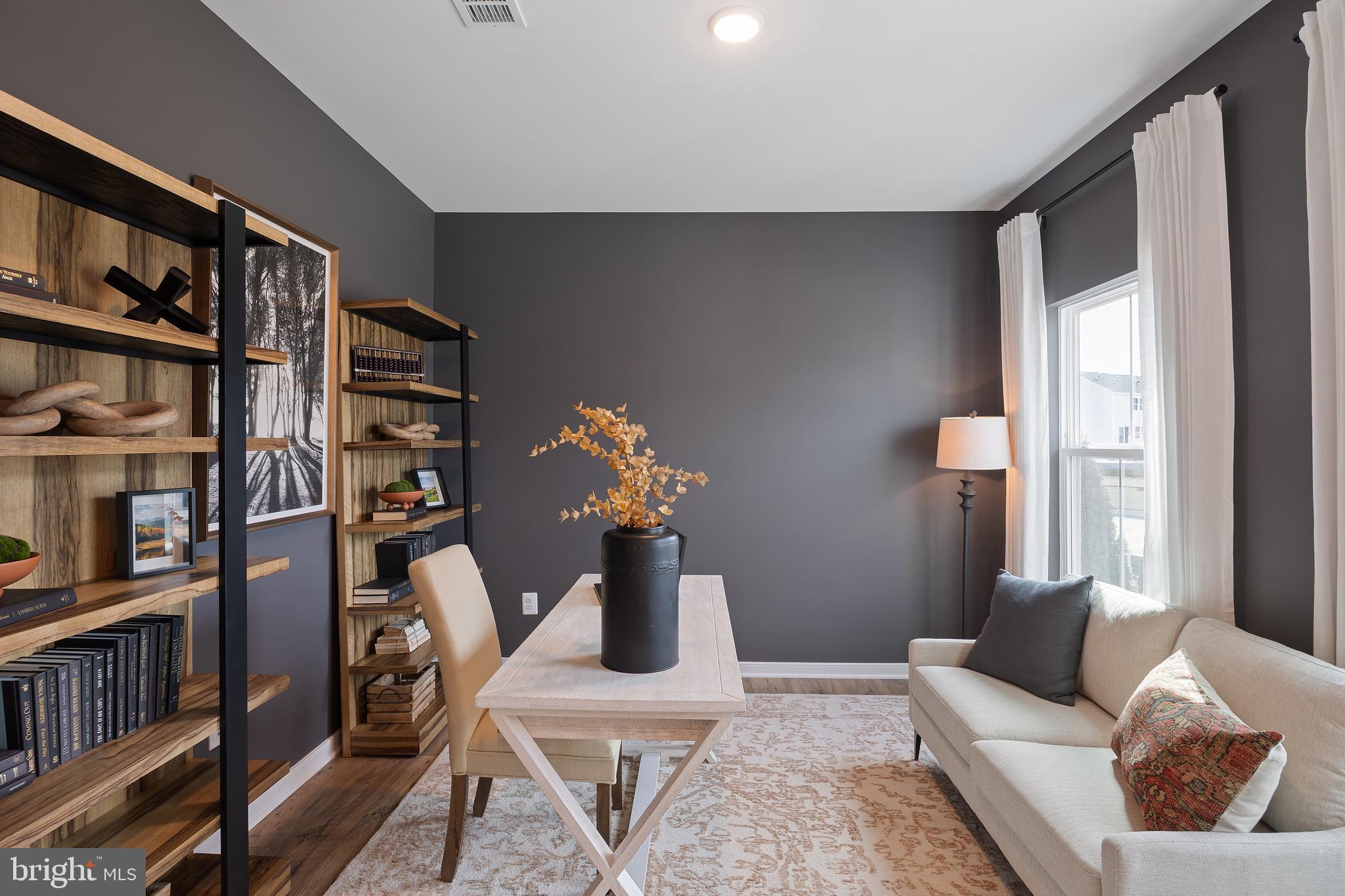 (lot 425-tbd Lot 425-tbd Street Ranson, WV 25438 - Photo 3 of 29 a living room with furniture and a book shelf