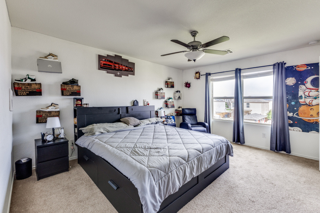 444 Major Lee Lane, Unit 14H Jarrell, TX 76537 - Photo 11 of 22 a spacious bedroom with a bed and a large window