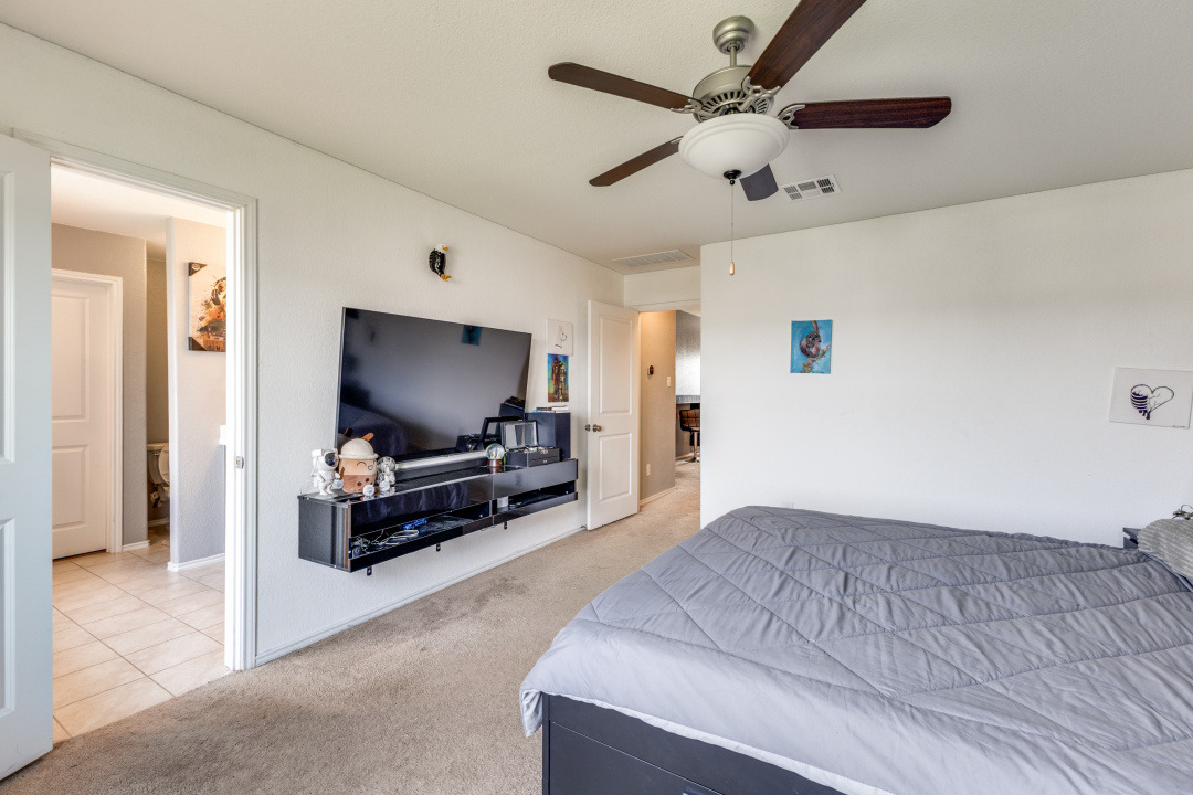 444 Major Lee Lane, Unit 14H Jarrell, TX 76537 - Photo 13 of 22 a living room with furniture and a flat screen tv