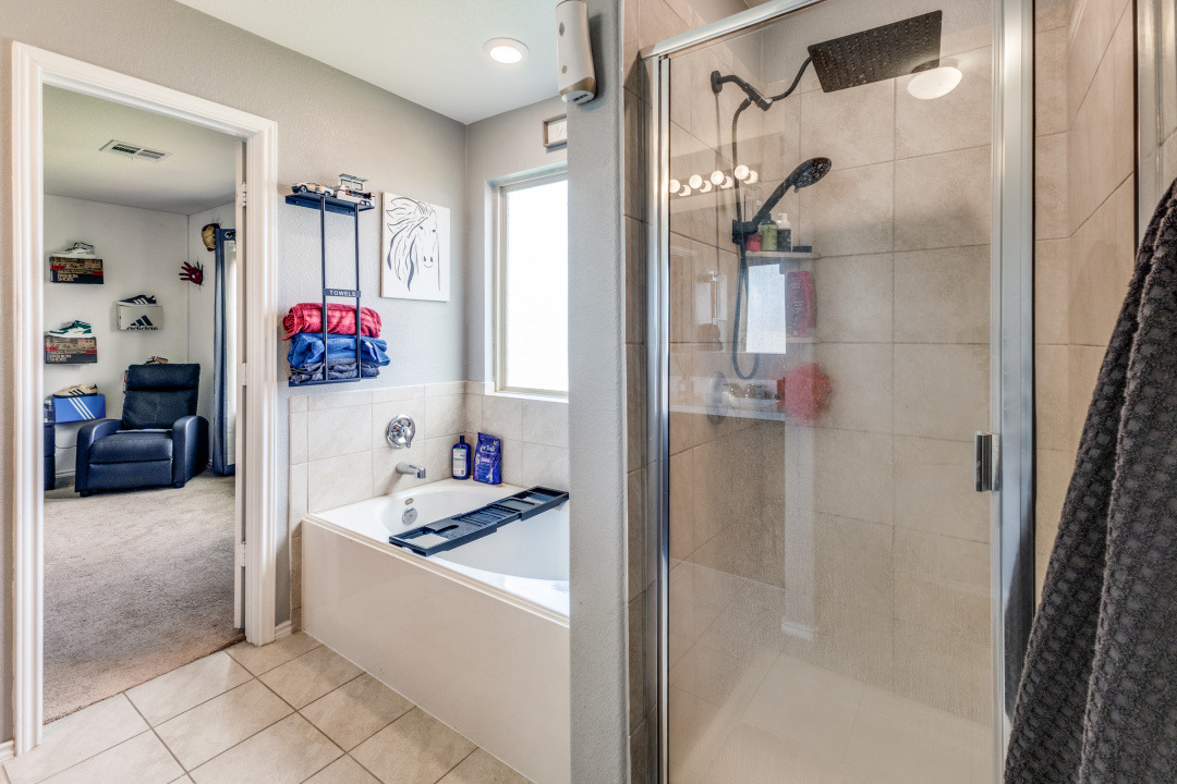 444 Major Lee Lane, Unit 14H Jarrell, TX 76537 - Photo 15 of 22 a bathroom with a tub shower and a sink