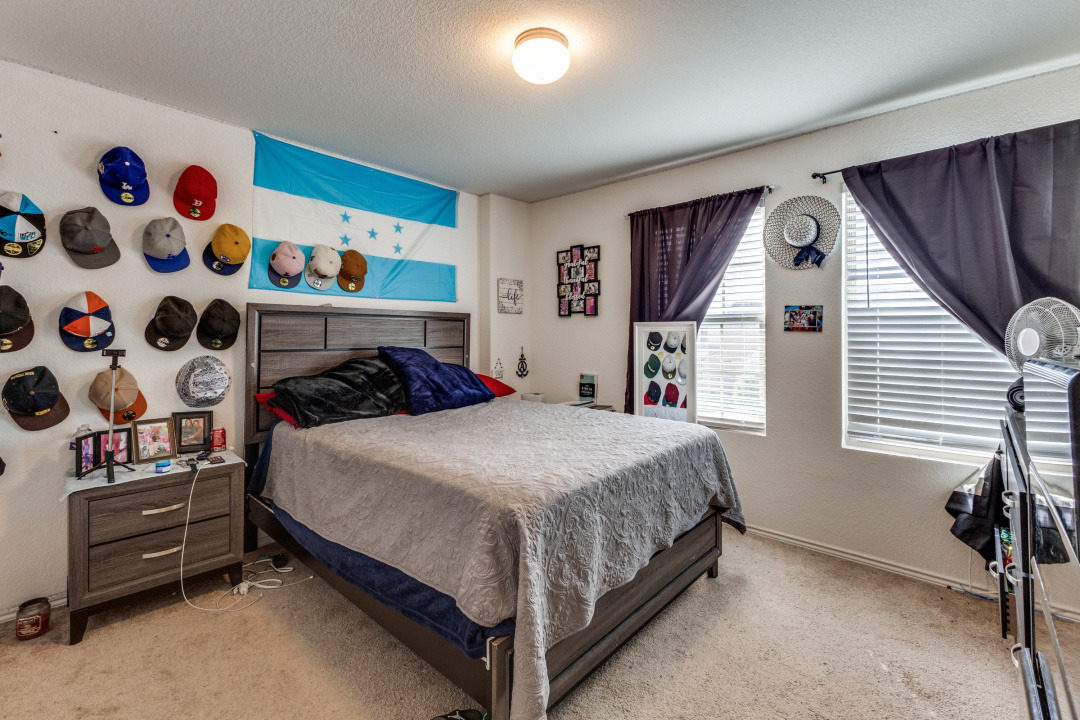 444 Major Lee Lane, Unit 14H Jarrell, TX 76537 - Photo 16 of 22 a bedroom with a bed and a window