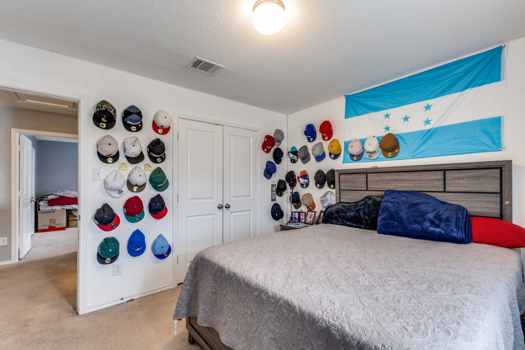 444 Major Lee Lane, Unit 14H Jarrell, TX 76537 - Photo 17 of 22 a bedroom with bed and a white cabinet