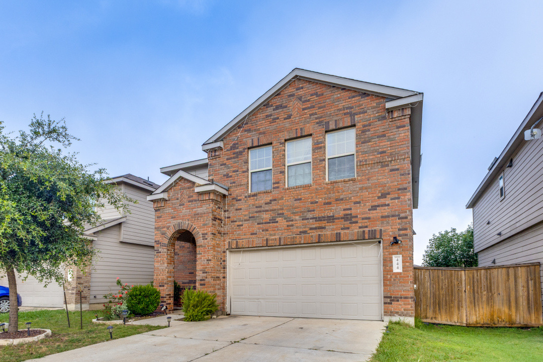 444 Major Lee Lane, Unit 14H Jarrell, TX 76537 - Photo 2 of 22 a front view of a house with a yard and garage