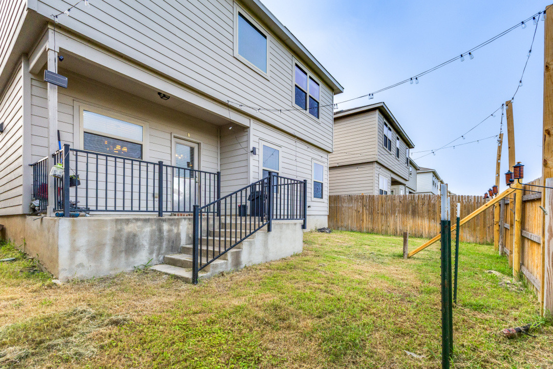 444 Major Lee Lane, Unit 14H Jarrell, TX 76537 - Photo 21 of 22 a view of a house with a small yard and wooden fence