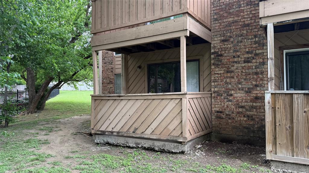 8110 Skillman Street, Unit 1016 Dallas, TX 75231 - Photo 11 of 12 Two-story property featuring a brick facade and private balconies with wood-finish railings