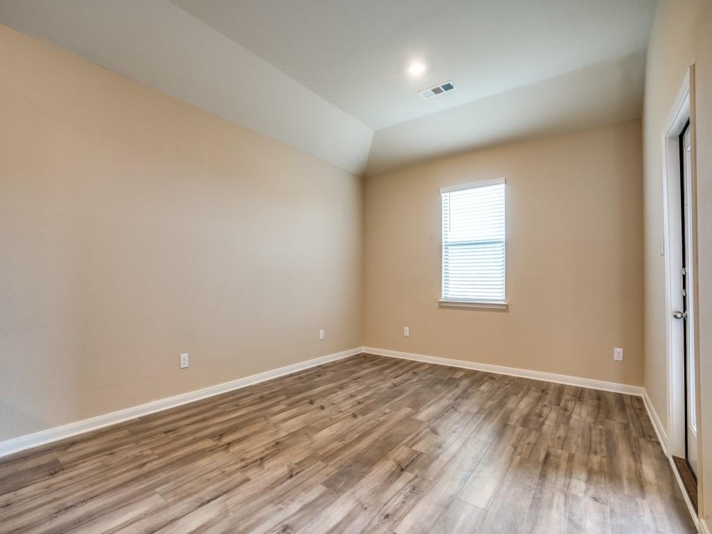 233 Enchanted Way Princeton, TX 75407 - Photo 11 of 25 wooden floor in an empty room with a window