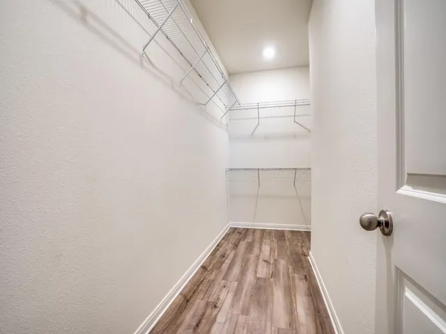 a view of a room with wooden floor