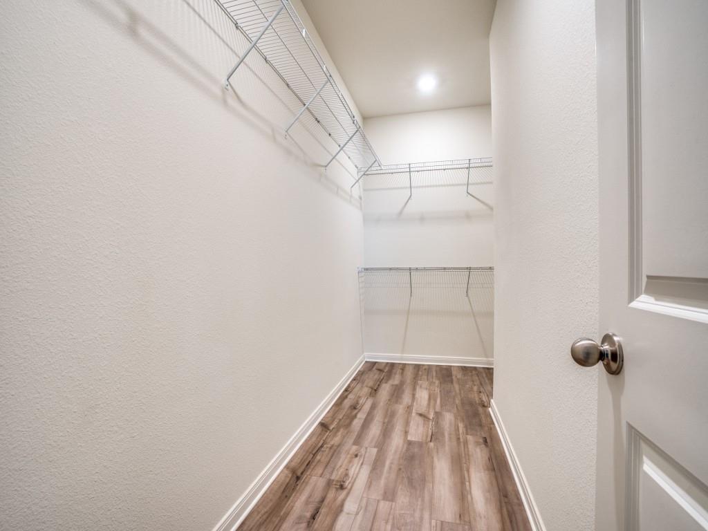 233 Enchanted Way Princeton, TX 75407 - Photo 16 of 25 a view of a room with wooden floor