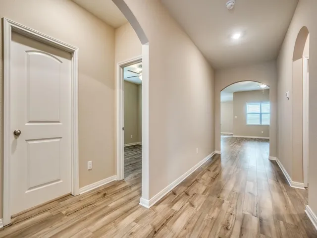 a view of hallway with wooden floor