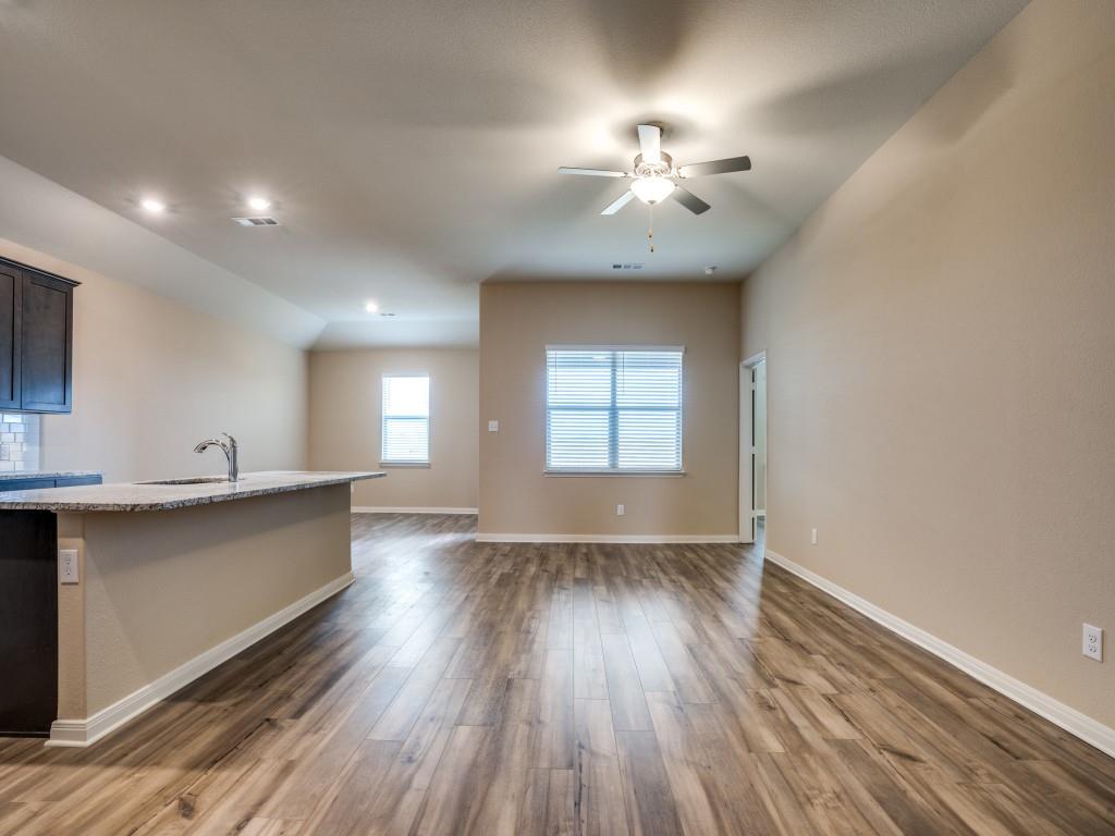 233 Enchanted Way Princeton, TX 75407 - Photo 4 of 25 a view of an empty room with window and wooden floor