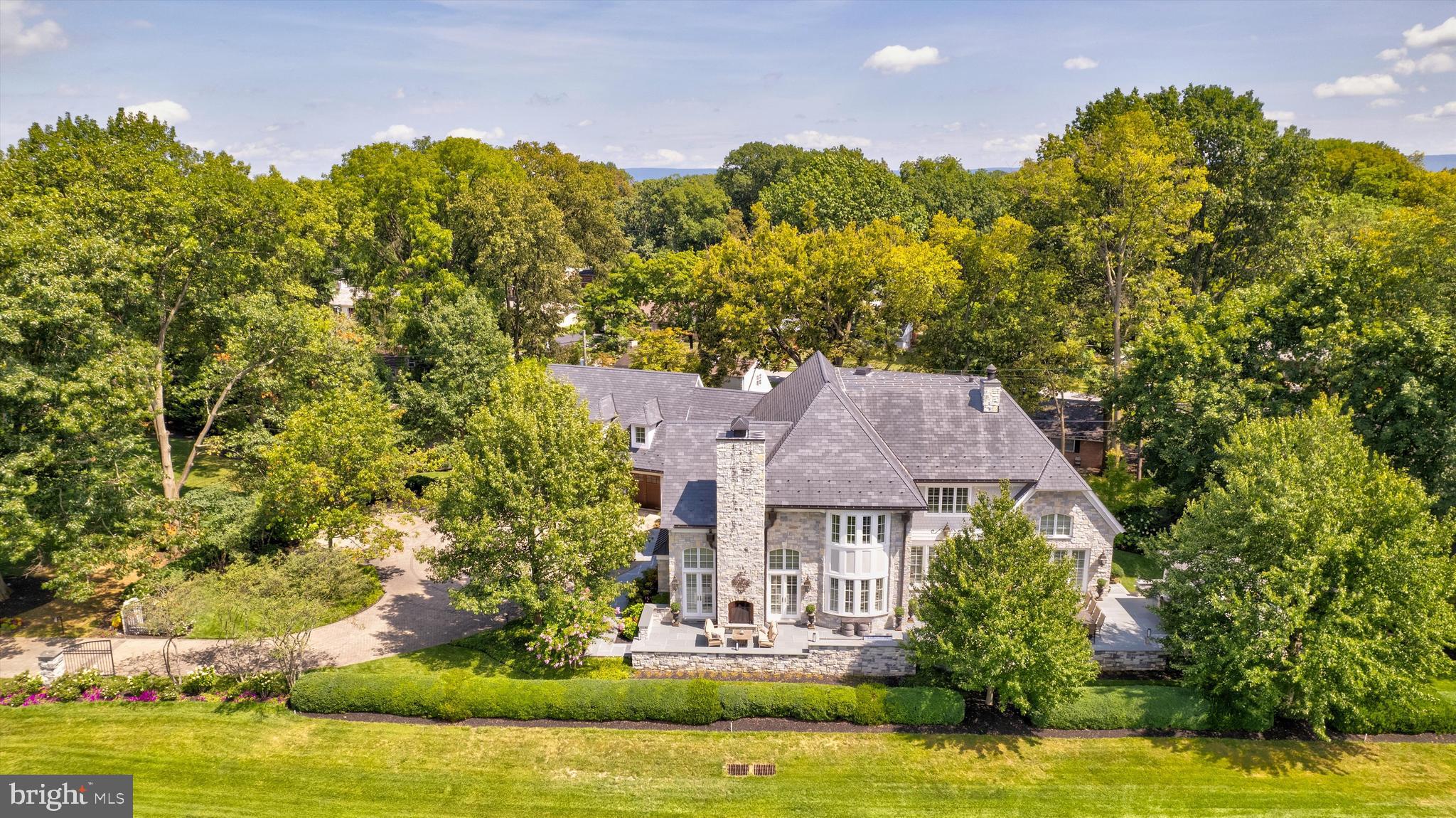 an aerial view of a house with a yard basket ball court and outdoor seating