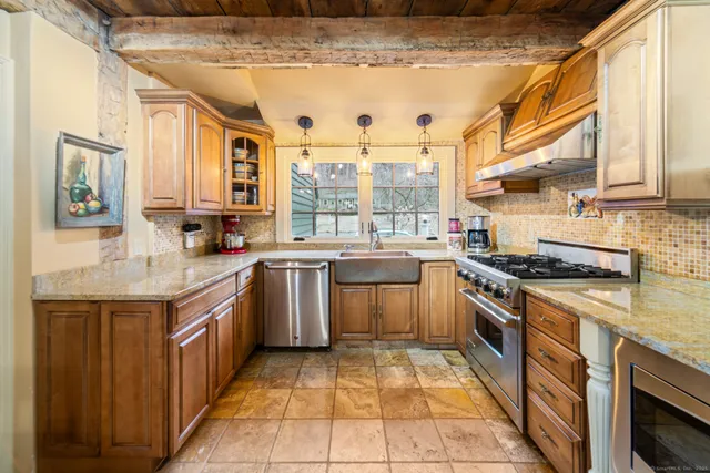 a kitchen with a sink stove and cabinets