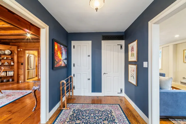 a view of a hallway with a dining area with chandelier