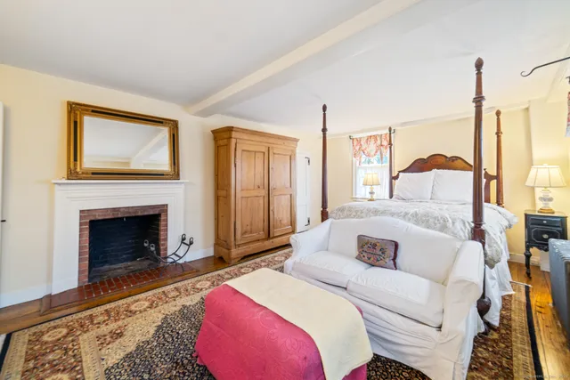 a bedroom with a bed and a fireplace