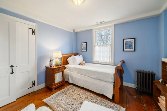 a bed room with a bed and a window