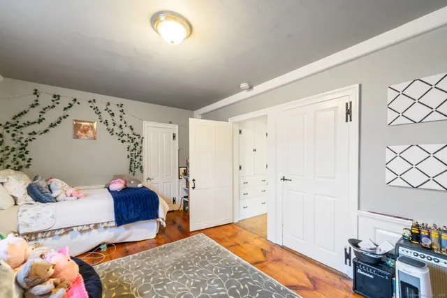 a bedroom with a bed and a dresser in it