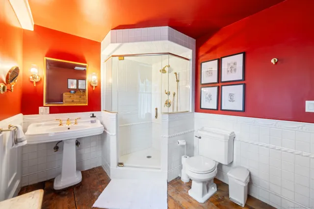 a bathroom with a sink a toilet and shower