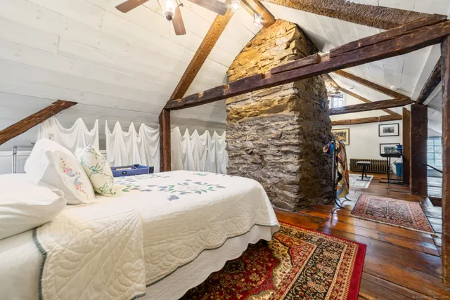 a bed sitting in a bedroom next to a window