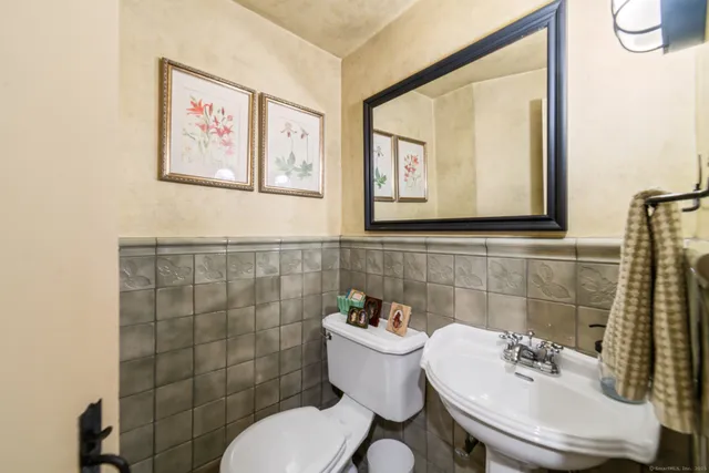 a bathroom with a sink mirror and toilet