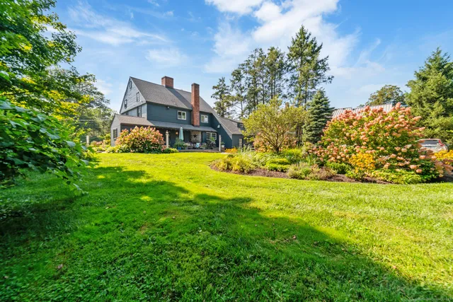 a front view of a house with a big yard