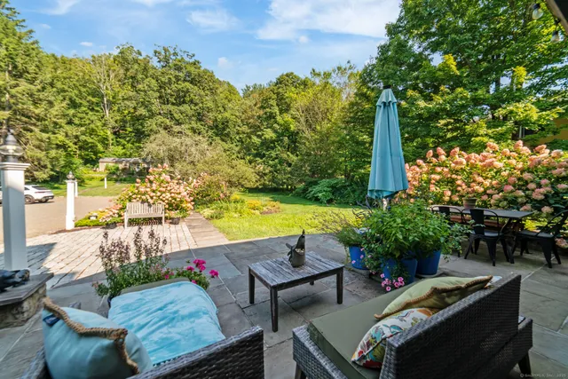 a view of a backyard with swimming pool and outdoor seating