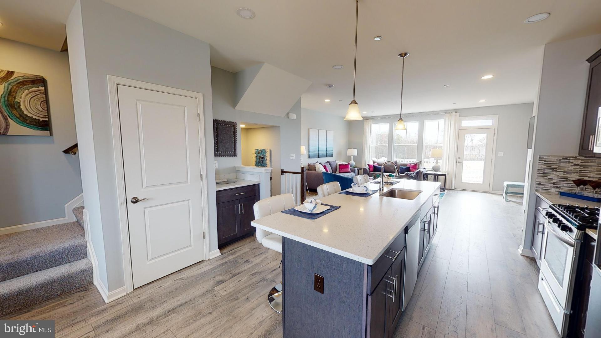 314 Purple Place Edgewood, MD 21040 - Photo 8 of 46 a kitchen with kitchen island a sink appliances and a dining table