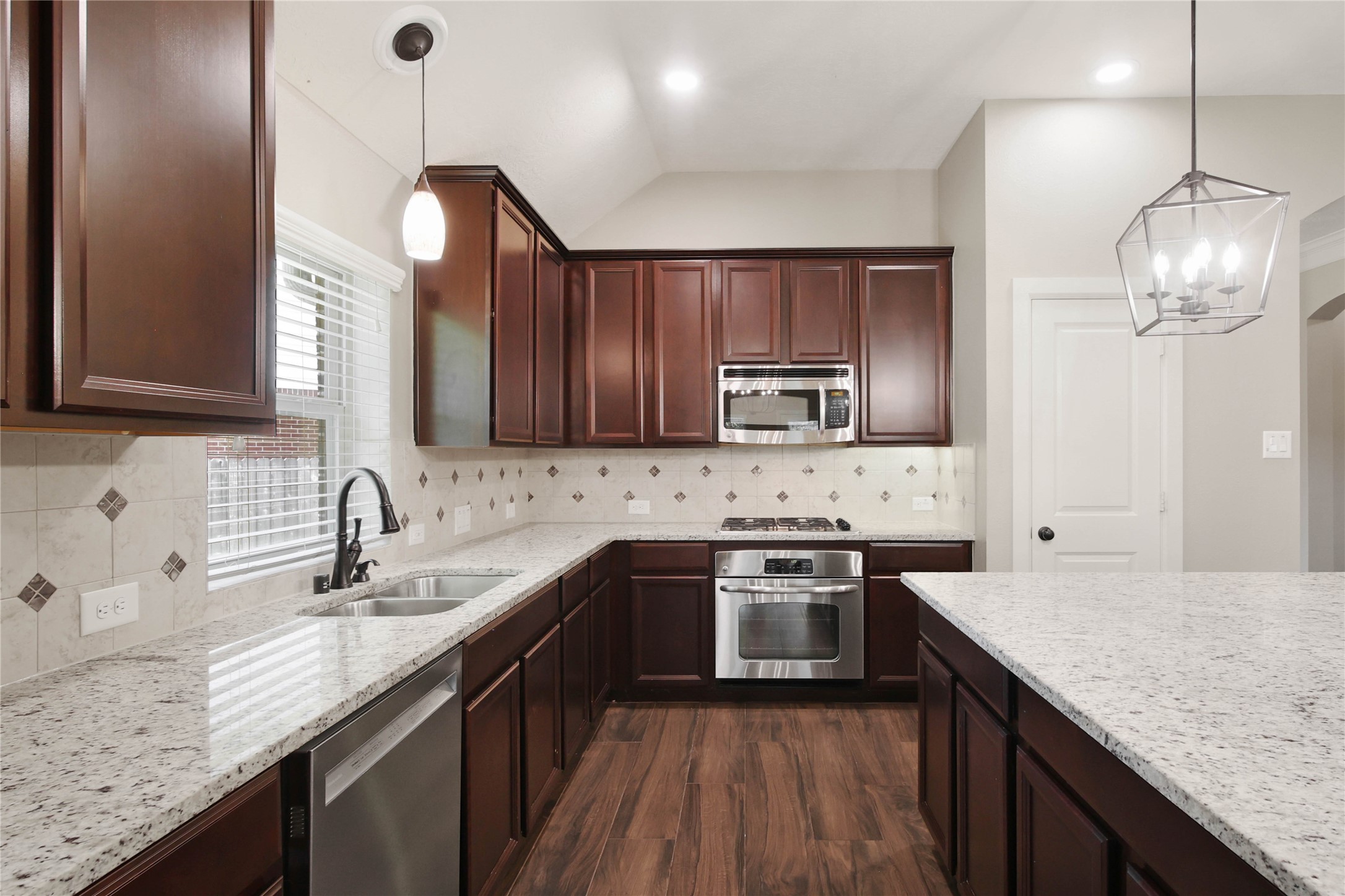 1215 Jake Springs Court Spring, TX 77386 - Photo 8 of 49 This is a delightful space to work with loads of counter space, upper cabinet lighting, stainless steel appliances, a gas cooktop, and abundant storage including a generous pantry with a built-in spice rack.