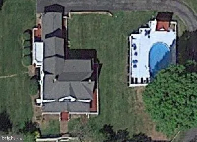 an aerial view of residential house with outdoor space and parking