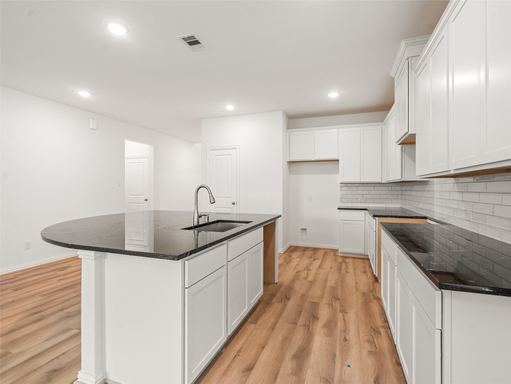 306 Strm Bnd Way Rosenberg, TX 77471 - Photo 11 of 35 a kitchen with a sink and cabinets
