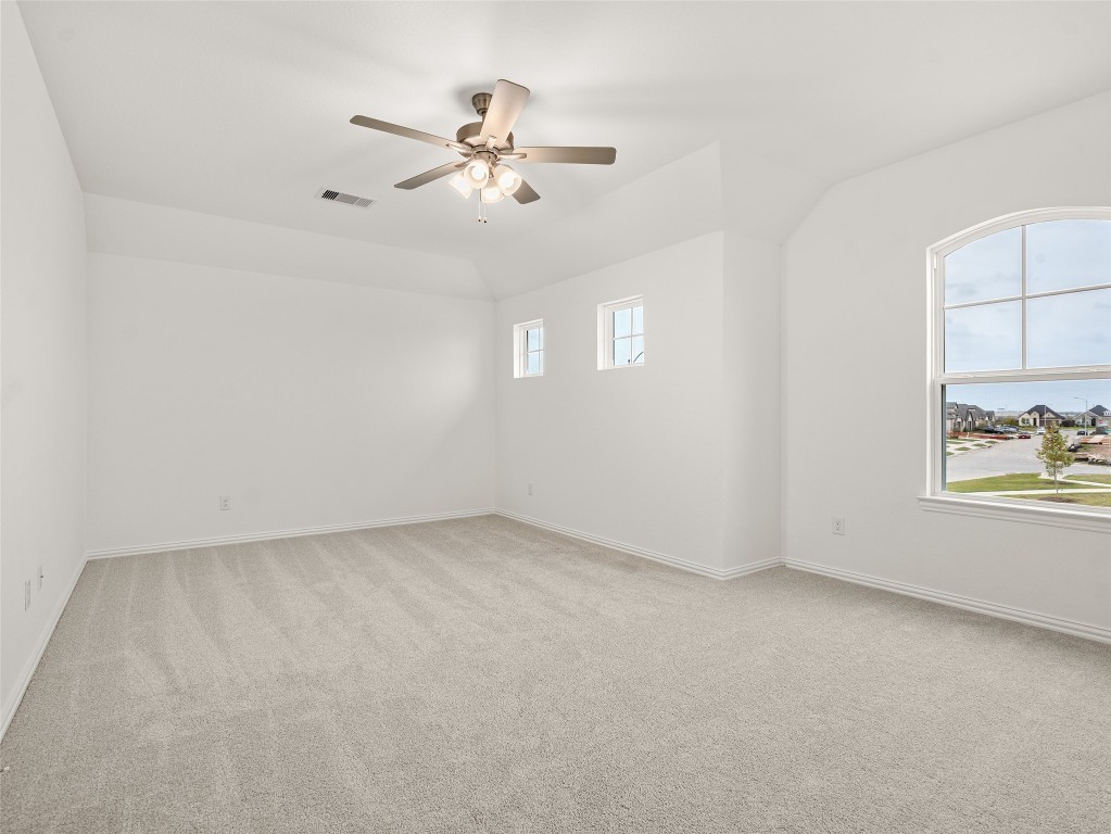 306 Strm Bnd Way Rosenberg, TX 77471 - Photo 25 of 35 an empty room with windows and fan