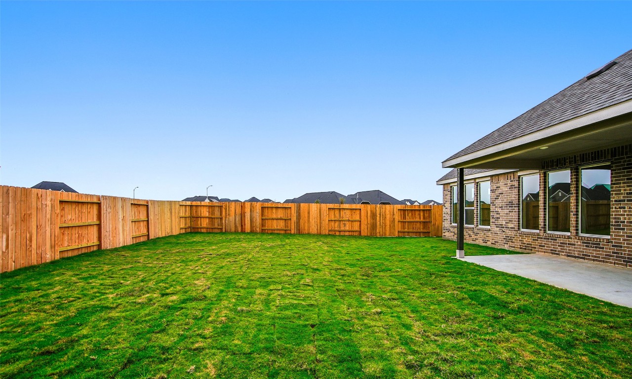 306 Strm Bnd Way Rosenberg, TX 77471 - Photo 33 of 35 a view of a backyard with potted plants and large tree