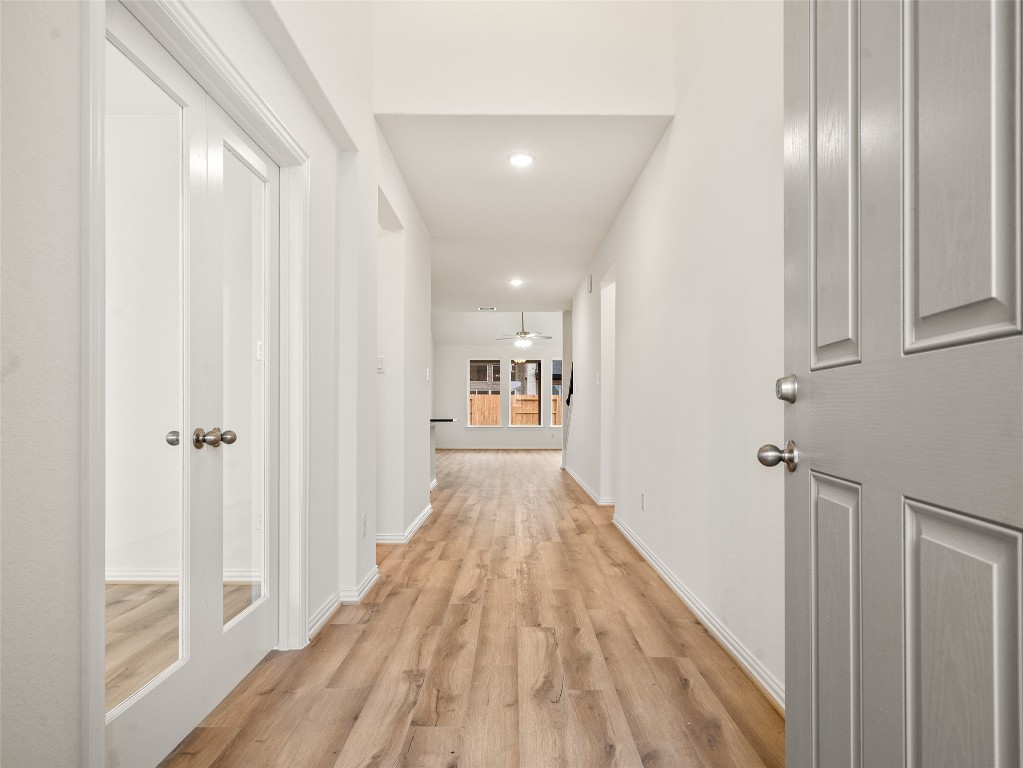 306 Strm Bnd Way Rosenberg, TX 77471 - Photo 4 of 35 a view of a hallway with wooden floor and staircase
