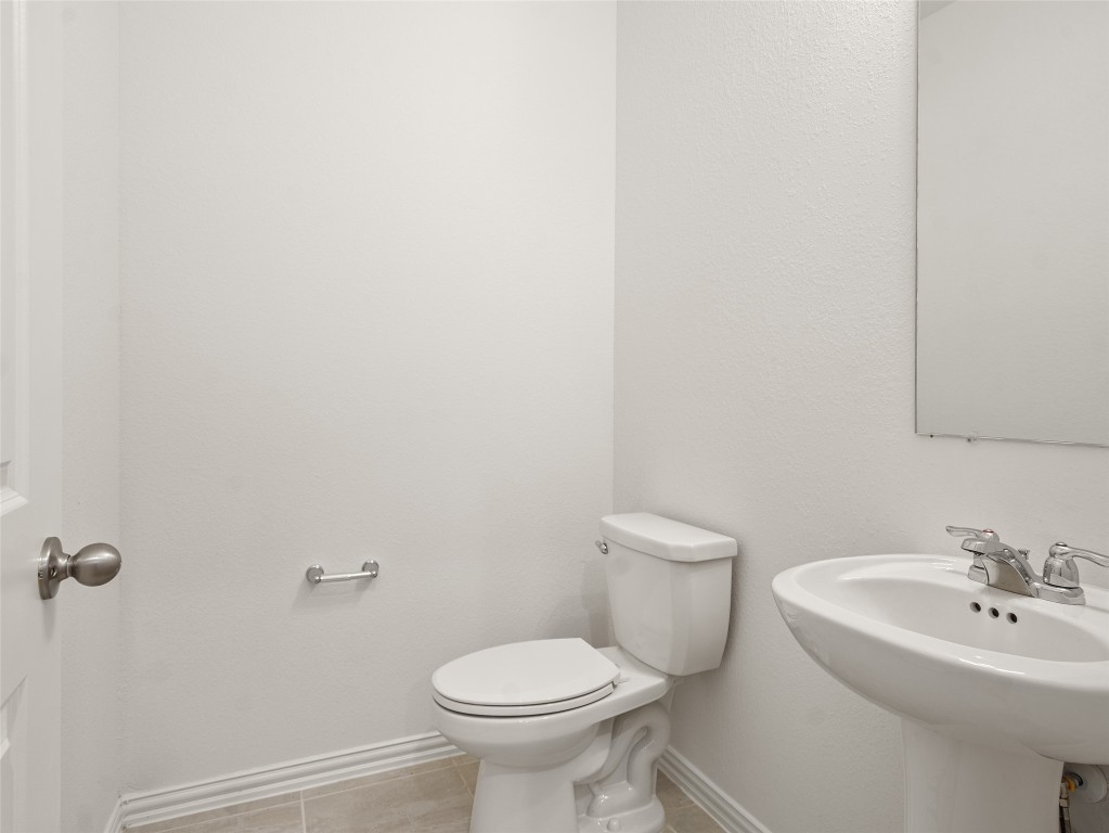 306 Strm Bnd Way Rosenberg, TX 77471 - Photo 8 of 35 a bathroom with a toilet sink and mirror