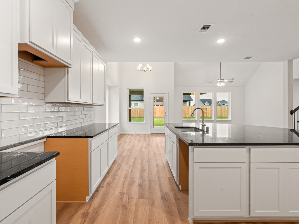 306 Strm Bnd Way Rosenberg, TX 77471 - Photo 10 of 35 a kitchen with granite countertop a sink a counter space appliances and cabinets