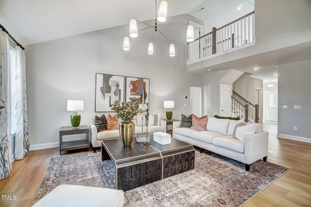 a living room with furniture and a chandelier