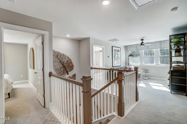 a bedroom with a bed and painting on the wall