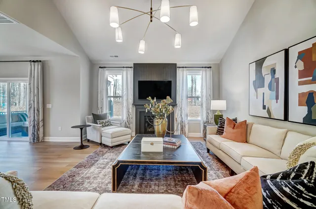 a living room with furniture and a chandelier