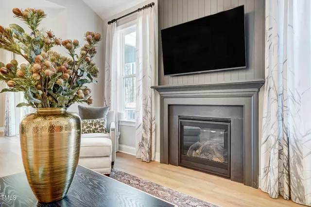 a living room with a fireplace and a flat screen tv